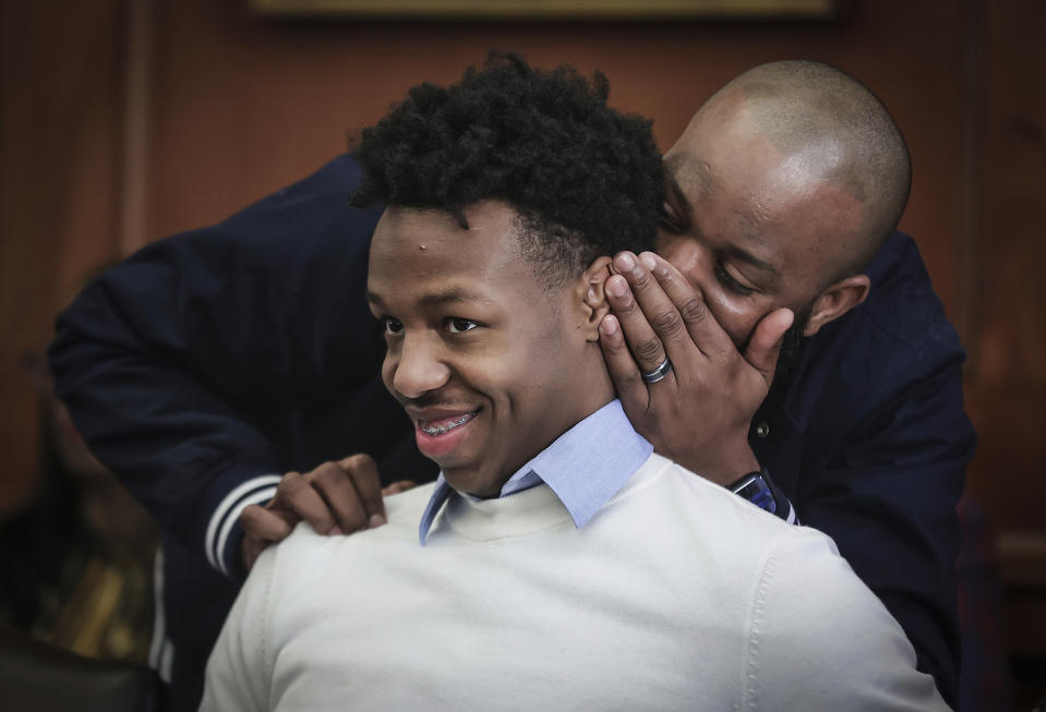 Joshua Holloway smiles as a comment is whispered in his ear during a hearing in Judge Carol Chumney's courtroom on Tuesday, Dec. 12, 2023 in Memphis, Tenn. The hearing is to determine whether Ja Morant used self defense during a fight last summer at his home. (Patrick Lantrip/Daily Memphian via AP)