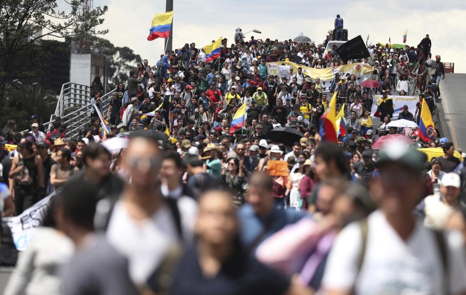 Anti-government demonstrators march in Bogota, Colombia, Wednesday, Dec. 4, 2019. Colombia’s recent wave of demonstrations began with a massive strike on Nov. 21 that drew an estimated 250,000 people to the streets. Protests have continued in the days since but at a much smaller scale. (AP Photo/Fernando Vergara)