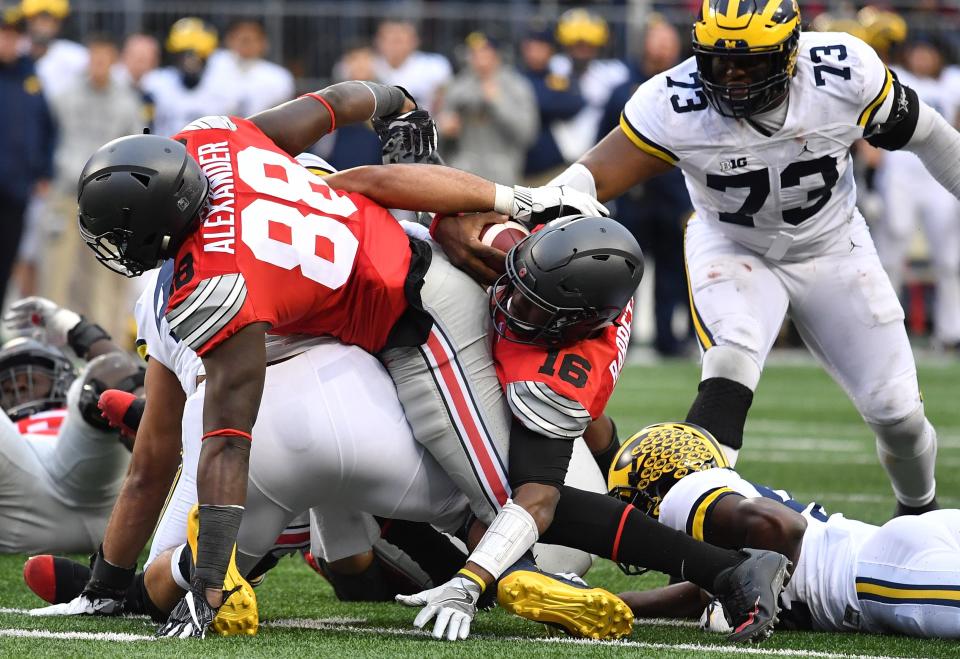 Ohio State's J.T. Barrett rushes for a first down in double overtime against Michigan at Ohio Stadium on Nov. 26, 2016.