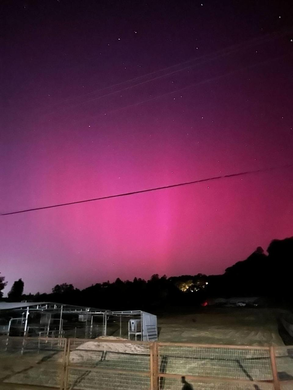 The northern lights turn the sky pink in a view from El Camino Real in Atascadero on May 10, 2024.