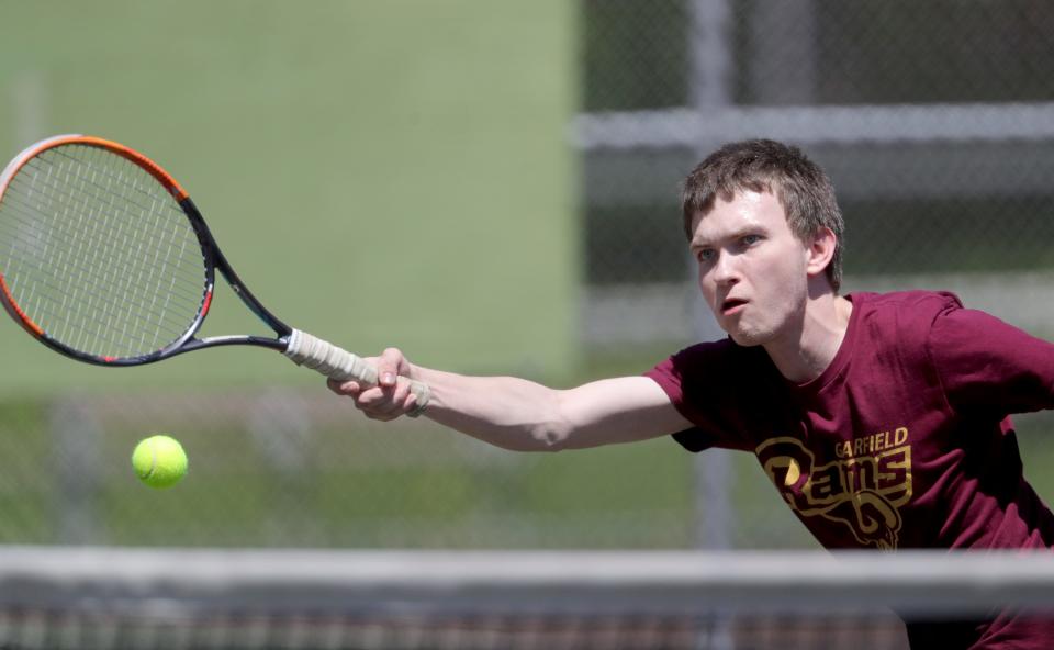 Kenmore-Garfield's Tyler Marr returns a volley during a match against Ellet's Niko Vitor in the City Series Tennis Tournament on Monday at Hyre Park.