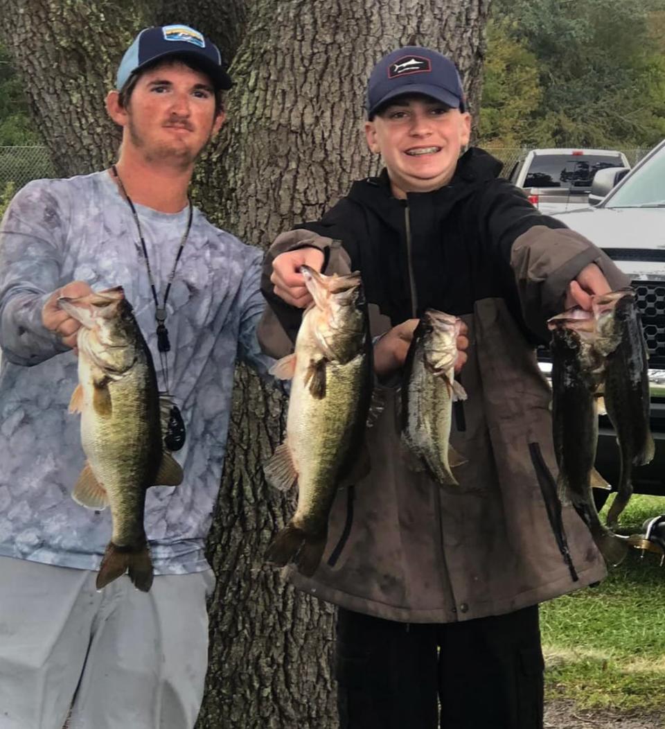 Dalton Jackson, 15, right, fishing solo had 10.78 pounds to win first place in Senior Division of the Lakeland Junior Hawg Hunters tournament Nov. 20 on Lake Kissimmee. At left is his boat captain Kyle Brewer.