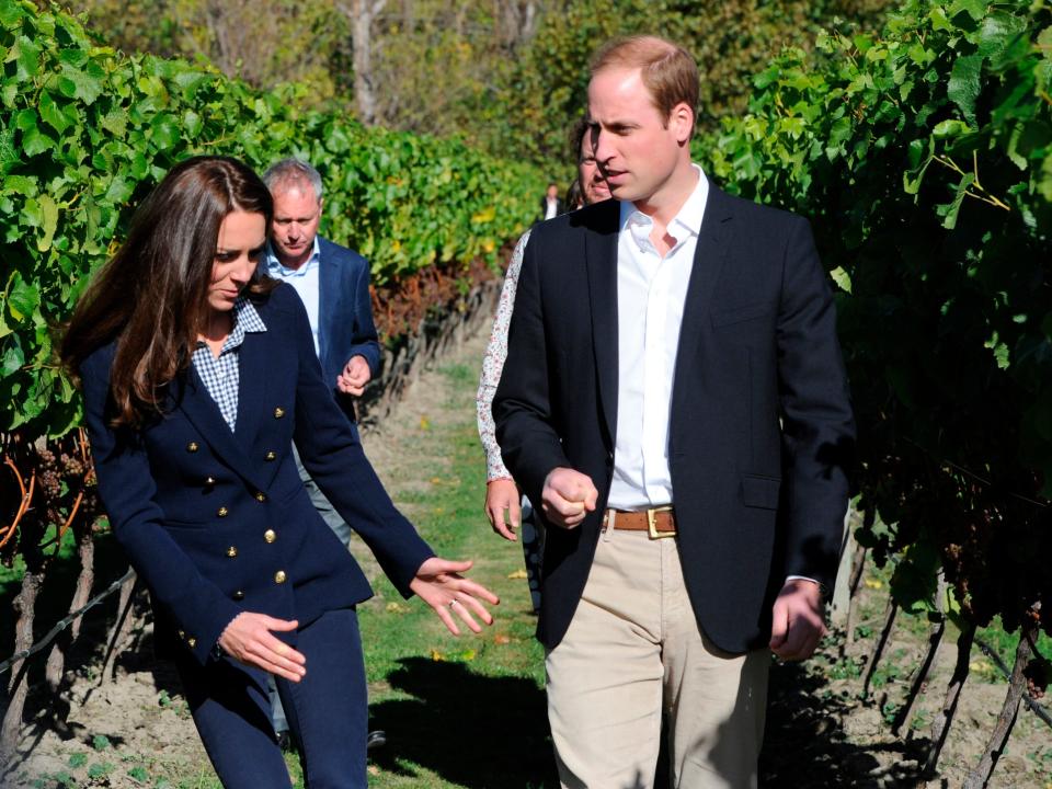 kate middleton, wearing a gap shirt, speaks with Prince William