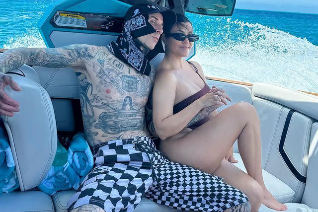<p>Travis Barker/Instagram</p> Travis Barker and Kourtney Kardashian on a boat.