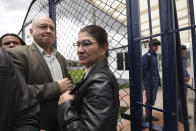 Former rebel leaders Carlos Antonio Losada, left, and Sandra Ramirez, both senators of the FARC political party, stand at the entrance to La Picota jail in Bogota, Colombia, Friday, May 17, 2019. Prison authorities said that Seuxis Hernandez, known by his war name Jesus Santrich, lacerated his arms and was receiving medical treatment inside the jail while waiting for release after the special tribunal investigating war crimes during Colombia's civil conflict ruled Wednesday that the former peace negotiator should not be extradited to the United States and freed from jail. (AP Photo/Fernando Vergara)