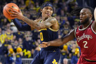 Michigan guard Dug McDaniel (0) looks to pass as Ohio State guard Bruce Thornton (2) defends during the second half of an NCAA college basketball game, Sunday, Feb. 5, 2023, in Ann Arbor, Mich. (AP Photo/Carlos Osorio)