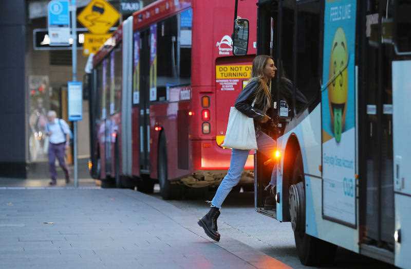 A woman boards a public bus, after an outbreak of the coronavirus disease (COVID-19), at Railway Square bus station in Sydney.