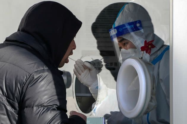 A man undergoes a routine COVID-19 test Nov. 29 at a site in Beijing. Chinese universities had been sending students home as the ruling Communist Party tightened coronavirus controls and tried to prevent more protests over 