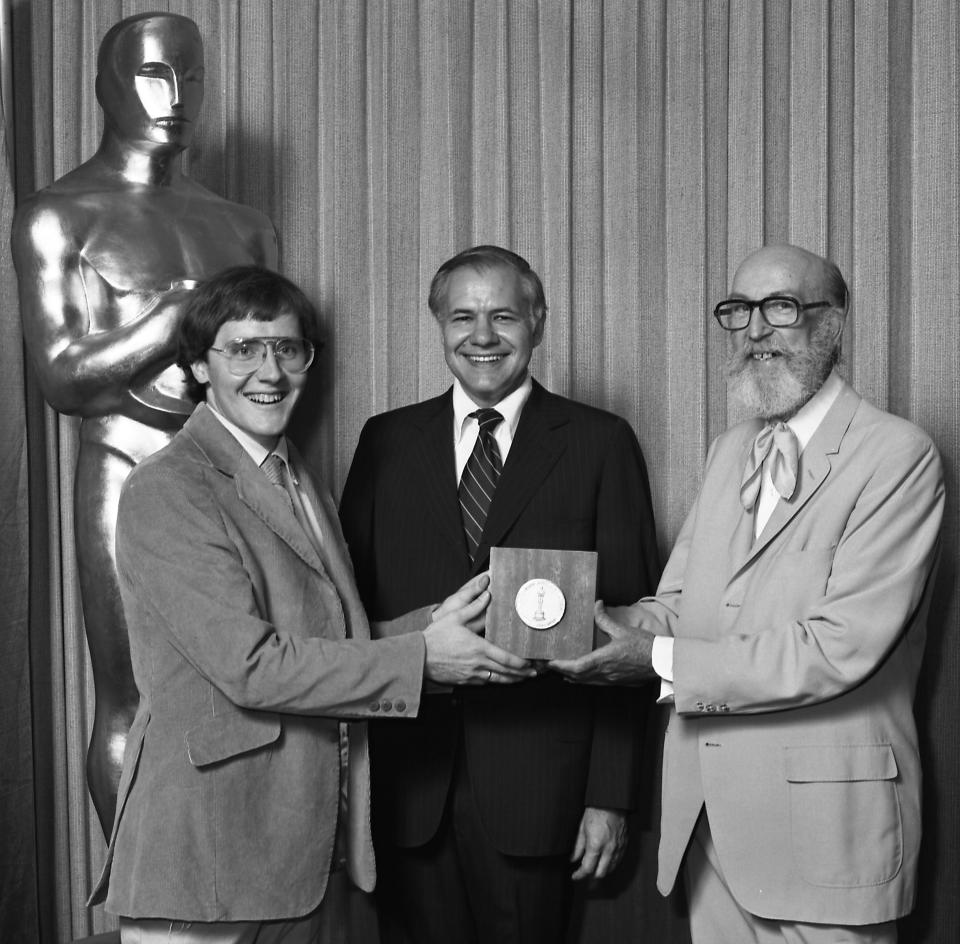 This undated publicity photo provided by the Motion Picture Academy of Arts and Sciences shows from left, John Lasseter, winner, Animation Achievement Award "Lady and the Lamp," at the 1979 (6th) Student Academy Awards ceremony, Don Honicky, head of college relations for the Bell System, and presenter film animator T. Hee in Beverly Hills, Calif. (AP Photos/AMPAS, Long Photography)