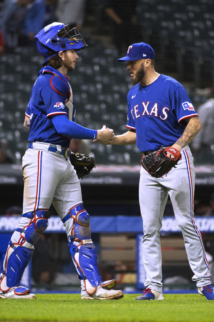 Texas Rangers catcher Jonah Heim congratulates reliever Joe Barlow after the Rangers defeated the Cleveland Guardians in the second game of a baseball doubleheader in Cleveland, Tuesday, June 7, 2022. (AP Photo/Phil Long)