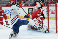 Detroit Red Wings goaltender Ville Husso (35) stops a Edmonton Oilers left wing Warren Foegele (37) shot in the third period of an NHL hockey game Tuesday, Feb. 7, 2023, in Detroit. (AP Photo/Paul Sancya)