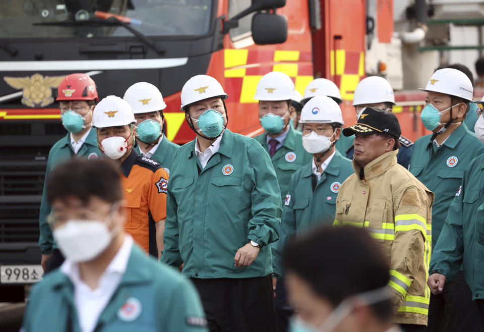 South Korean President Yoon Suk Yeol, top fourth from left, arrives at the site of a fire at a lithium battery manufacturing factory in Hwaseong, South Korea, Monday, June 24, 2024. (Ryu Hyung-seok/Yonhap via AP)
