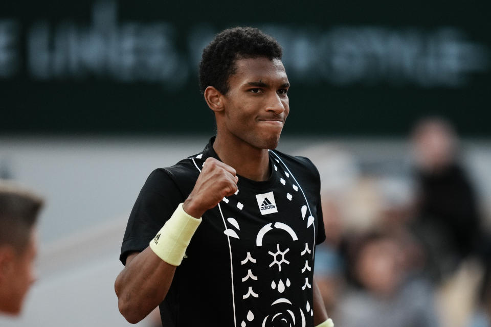 Canada's Felix Auger-Aliassime clenches his fist after scoring a point against Spain's Rafael Nadal during their fourth round match at the French Open tennis tournament in Roland Garros stadium in Paris, France, Sunday, May 29, 2022. (AP Photo/Thibault Camus)