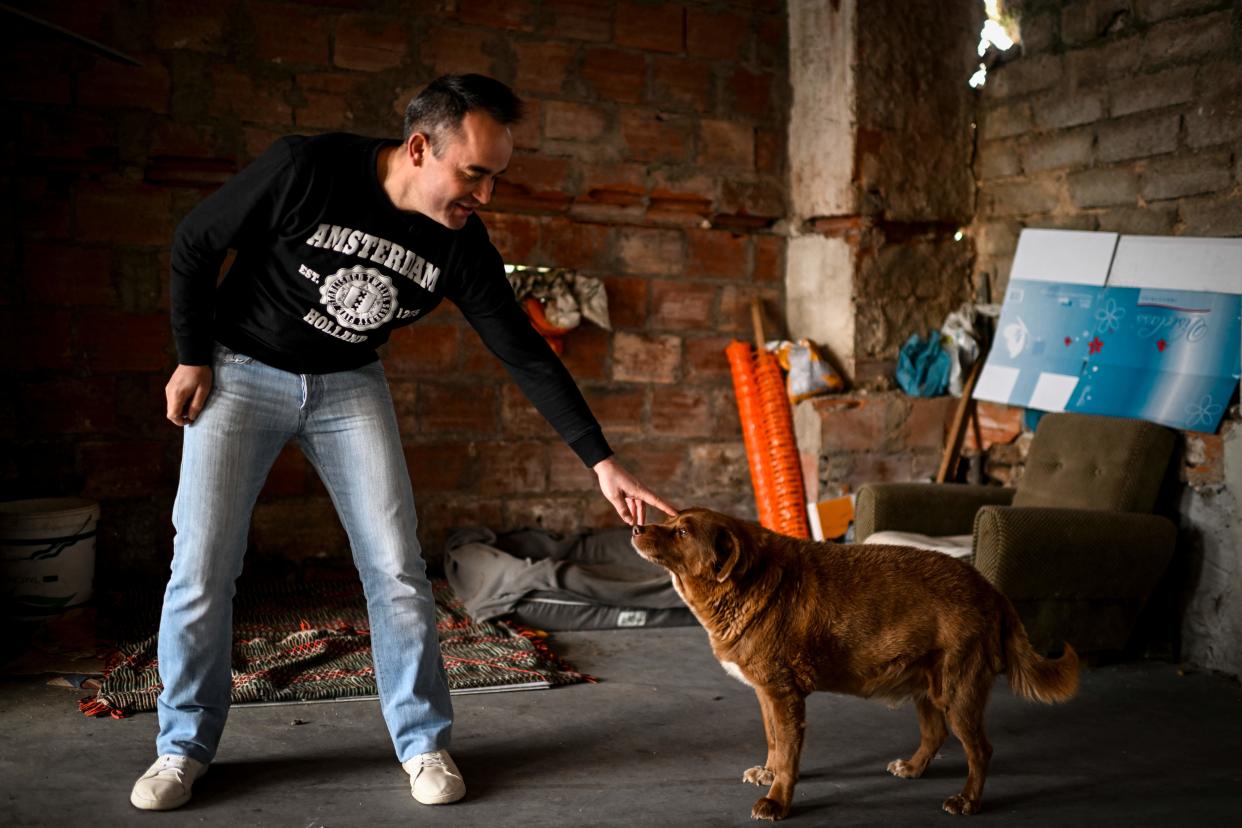 Owner Leonel Costa with Bobi at their home in the village of Conqueiros near Leiria, Portugal. (Patricia de Melo Moreira/AFP via Getty Images)