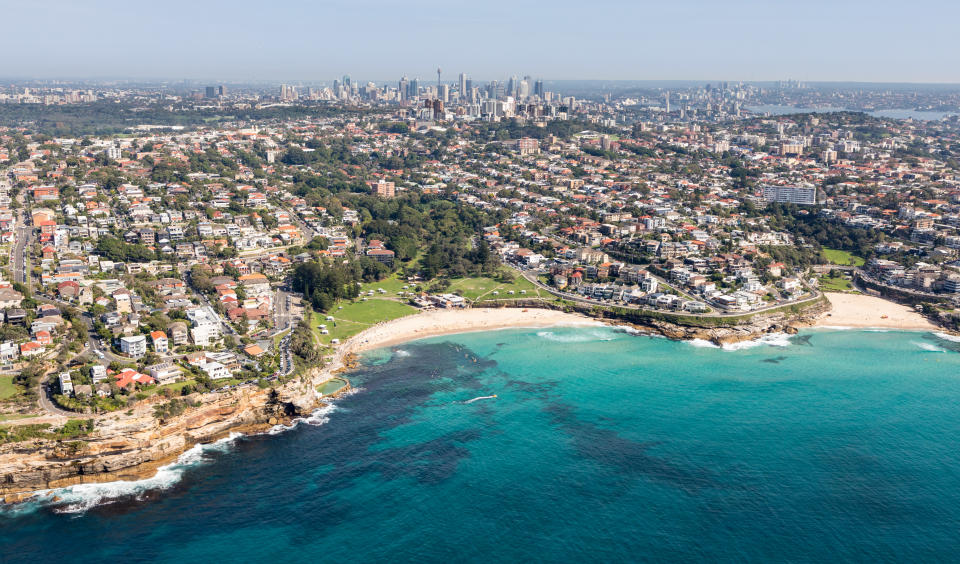 Aerial view of oceanside property with the Sydney CBD in the background. 