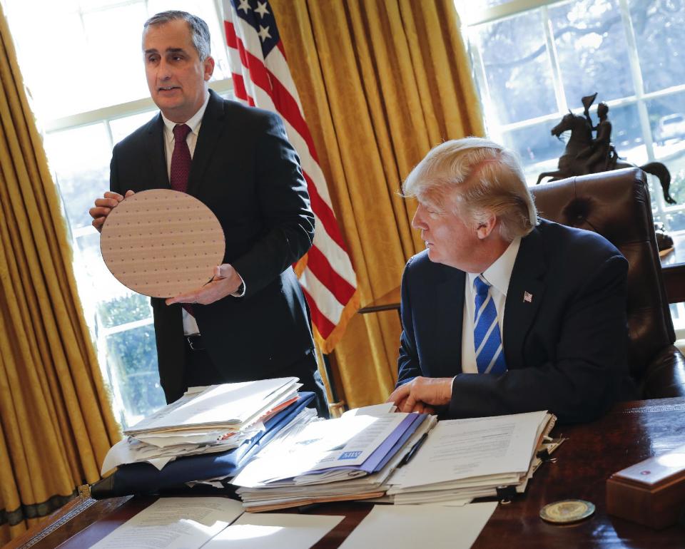 President Donald Trump looks at Intel CEO Brian Krzanich, holding a silicon wafer, during their meeting in the Oval Office of the White House in Washington, Wednesday, Feb. 8, 2017. (AP Photo/Pablo Martinez Monsivais)