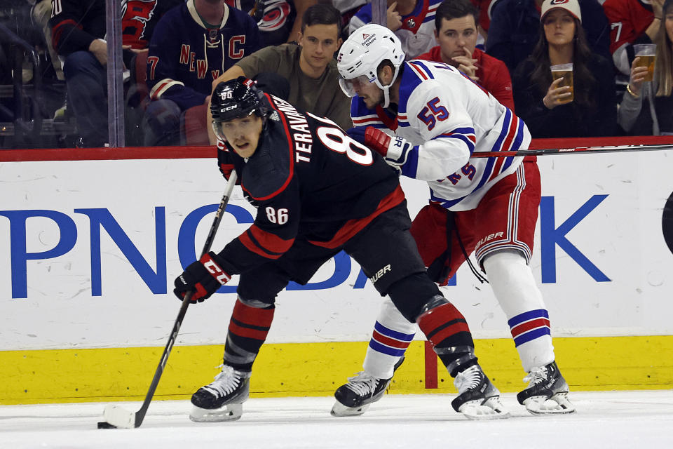 Carolina Hurricanes' Teuvo Teravainen (86) protects the puck from New York Rangers' Ryan Lindgren (55) during the first period in Game 4 of an NHL hockey Stanley Cup second-round playoff series in Raleigh, N.C., Saturday, May 11, 2024. (AP Photo/Karl B DeBlaker)