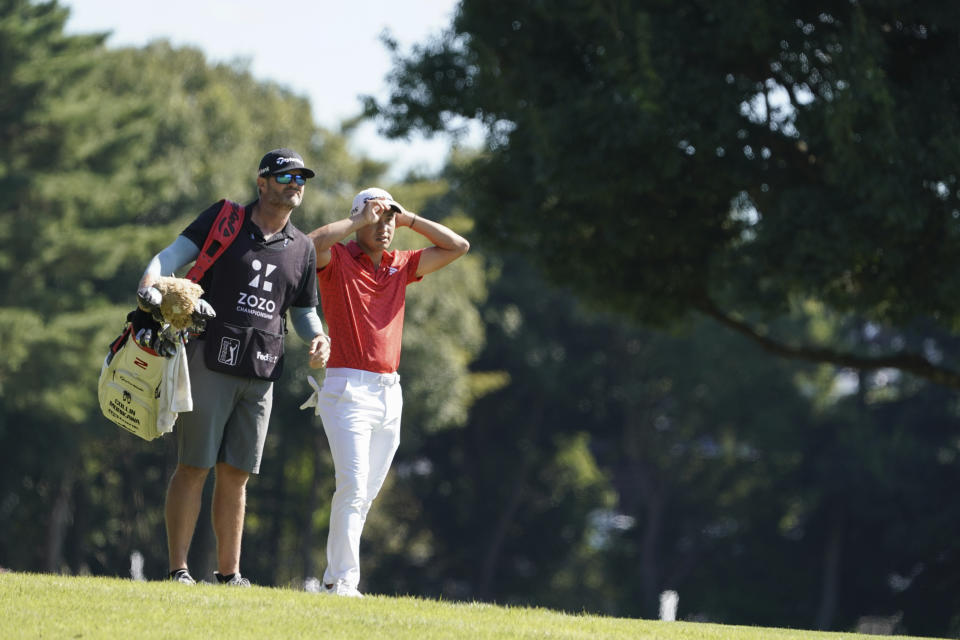 Collin Morikawa of the United States, right, is seen on the second hole in the final round of the PGA Tour Zozo Championship at the Narashino Country Club in Inzai on the outskirts of Tokyo, Sunday, Oct. 22, 2023. (AP Photo/Tomohiro Ohsumi)