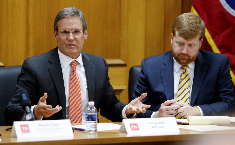 Bill Lee, left, the Republican governor of Tennessee, leads his first cabinet meeting on Jan. 22, 2019, in Nashville. At right is Blake Harris, his chief of staff.
