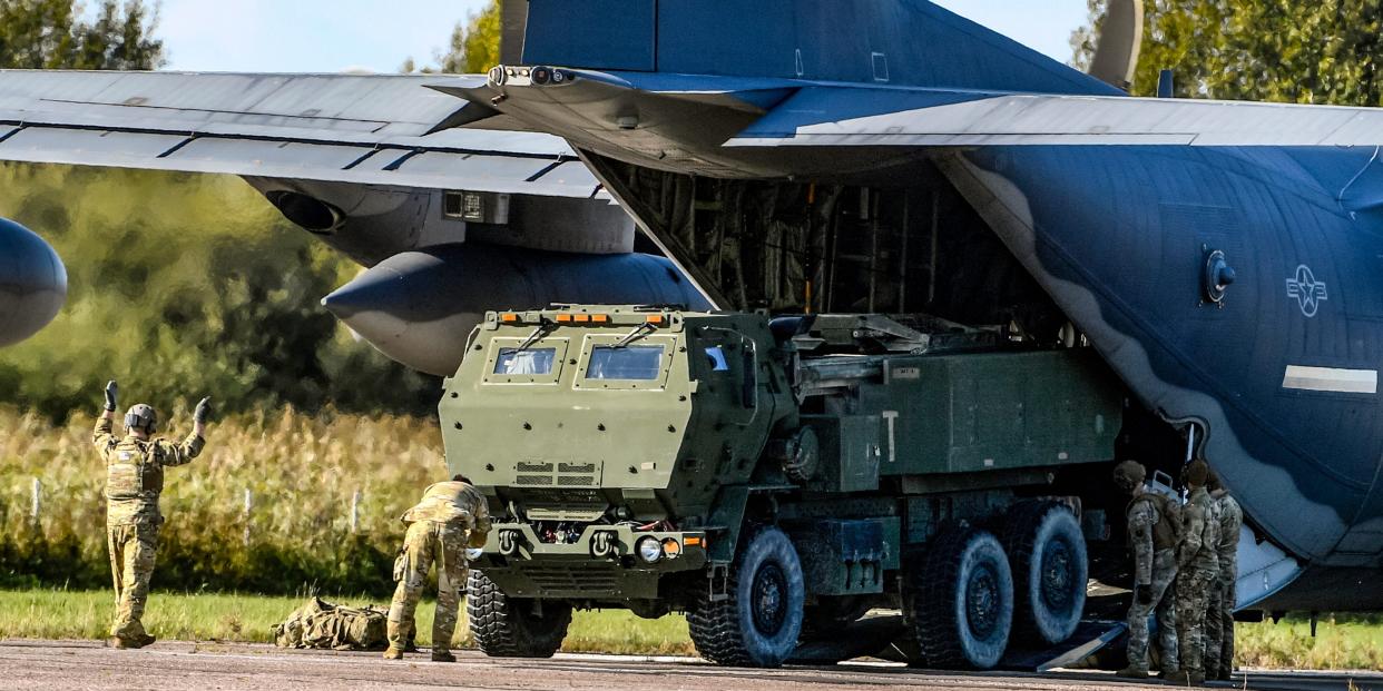 HIMARS system being loaded into back of plane on runway