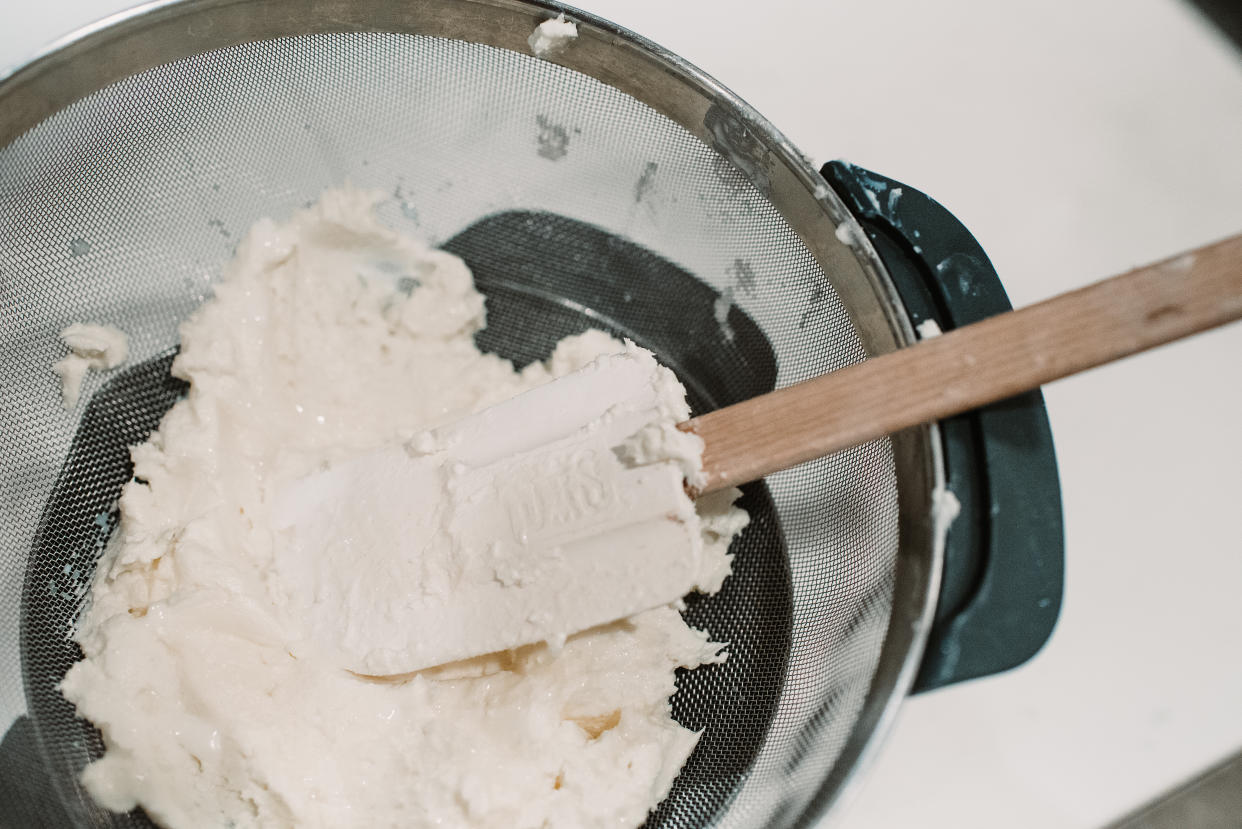 Homemade butter can be strained by placing butter in a fine sieve over a bowl and using a spatula to press out as much buttermilk as possible. (Photo: Jamie Davis Smith)