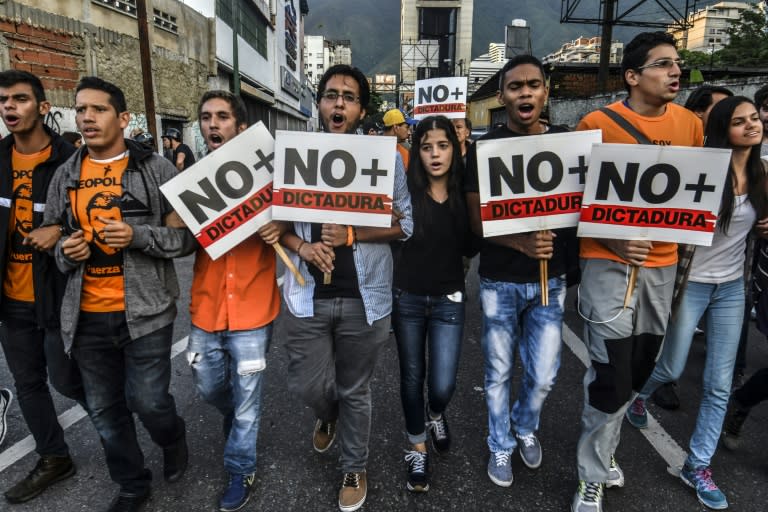 Opposition demonstrators march towards the Organisation of American States (OAS) headquarters in Caracas on June 21, 2017, after the 47th OAS General Assembly taking place in Cancun, Mexico, ruled out issuing a resolution on Venezuela