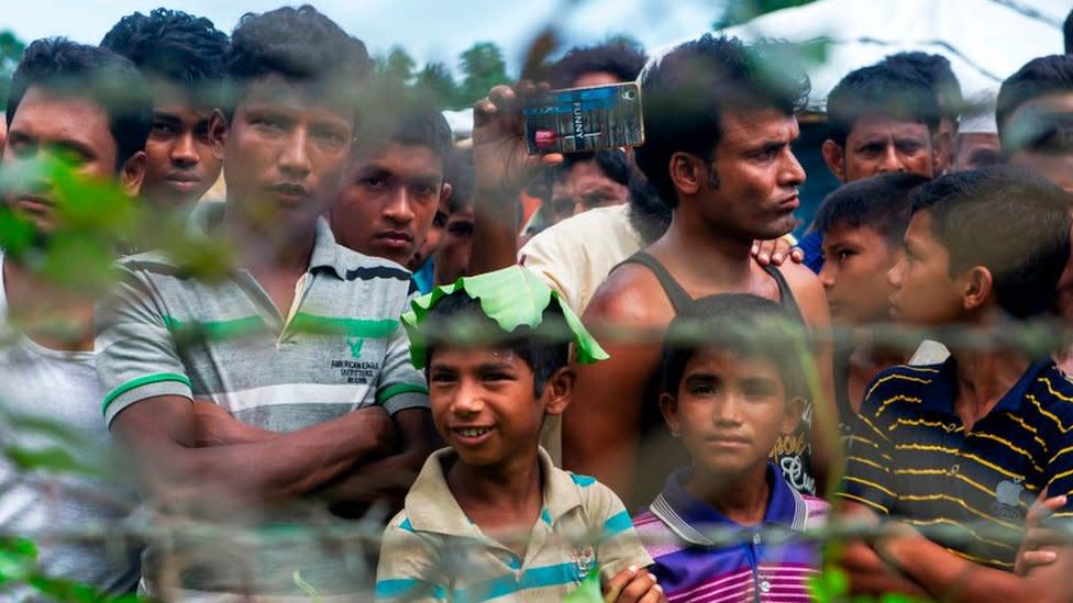 Rohingya refugees gather near the fence in the "no man's land" between Myanmar and Bangladesh border as seen from Maungdaw, Rakhine state, on June 29, 2018