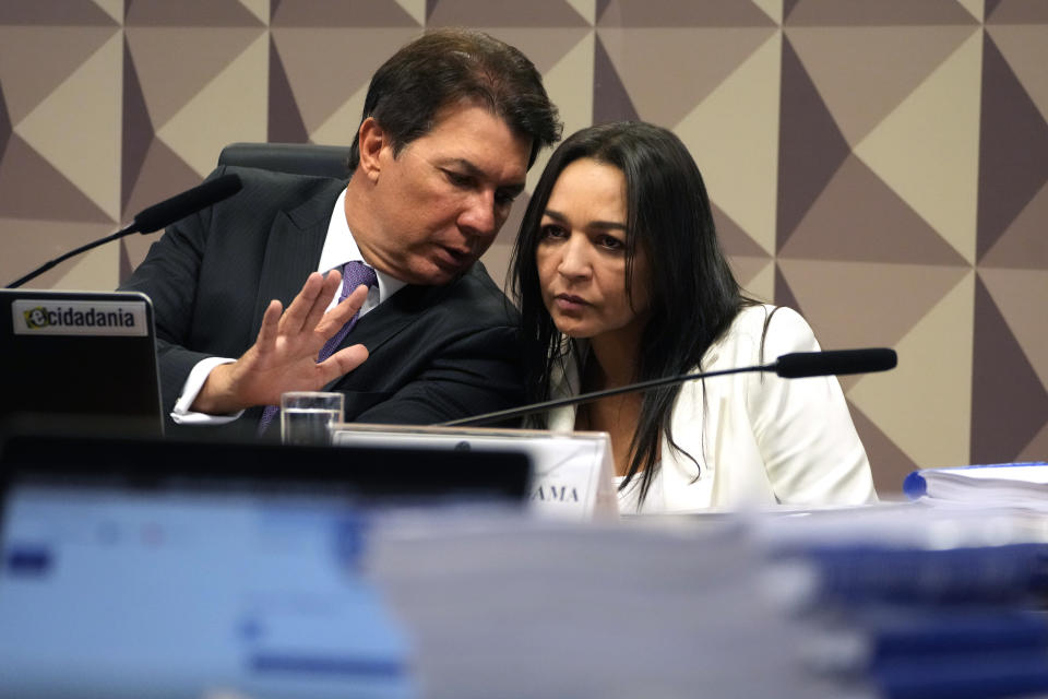 Senator Eliziane Gama, right, talks with Commission President Deputy Arthur Maia during a vote by the Parliamentary Inquiry Committee on her congressional report about the Jan. 8 riots, at the Federal Senate in Brasilia, Brazil, Wednesday, Oct. 18, 2023. The report accuses ex-President Jair Bolsonaro of being the insurrection's mastermind. (AP Photo/Eraldo Peres)