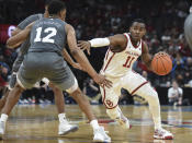 Oklahoma guard De'Vion Harmon (11) pushes past Mississippi State guard Robert Woodard (12) during the first half of an NCAA college basketball game in Oklahoma City, Saturday, Jan. 25, 2020. (AP Photo/Kyle Phillips)