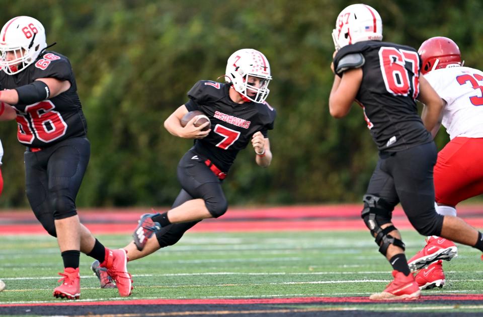 HYANNIS 9/22/23 Barnstable quarterback Aiden Kundel looks for an opening in the Bridgewater-Raynham line.