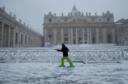 A man skis during a heavy snowfall in Saint Peter's Square at the Vatican. REUTERS/Max Rossi