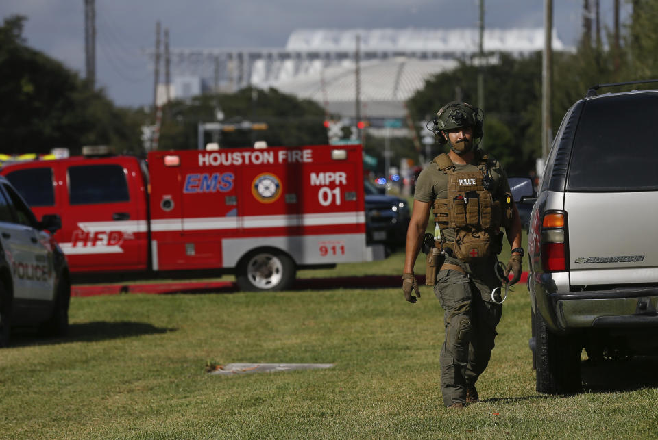 Law enforcement officials at the scene of an officer-involved shooting at an apartment complex on Tuesday, Oct. 20, 2020, in Houston. Two Houston officers were shot before a SWAT team was dispatched to the scene, where the suspected shooter was arrested, authorities said. (Godofredo A. Vásquez / Houston Chronicle via AP)