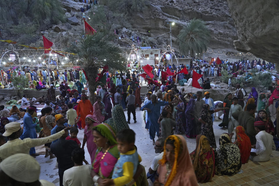 Hindu devotees arrive at an ancient cave temple of Hinglaj Mata to attend an annual festival in Hinglaj in Lasbela district in Pakistan's southwestern Baluchistan province, Friday, April 26, 2024. More than 100,000 Hindus are expected to climb mud volcanoes and steep rocks in southwestern Pakistan as part of a three-day pilgrimage to one of the faith's holiest sites. (AP Photo/Junaid Ahmed)