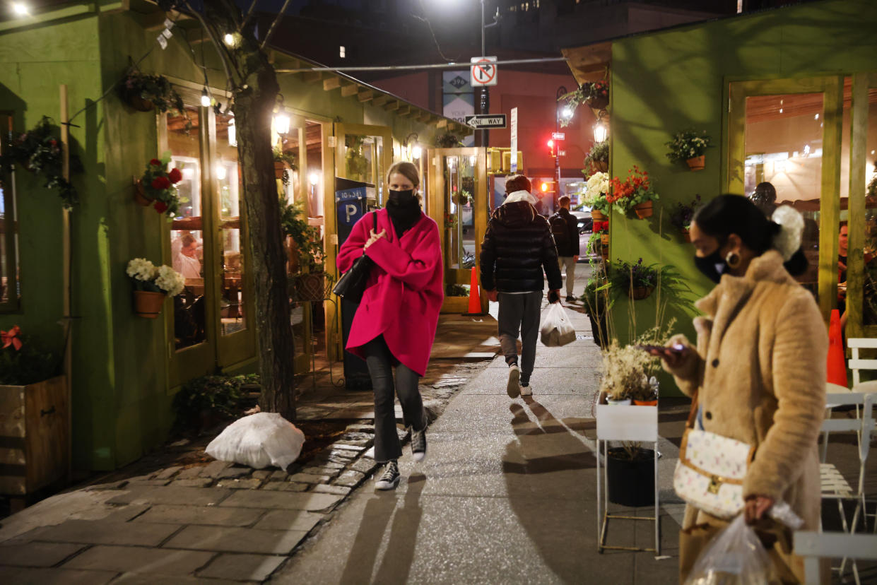 Strollers in New York City enjoy a warm evening in February. 