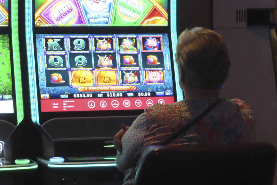 A gambler plays a slot machine at Harrah's casino in Atlantic City, N.J., on Sept. 29, 2023. On Nov. 21, 2023, New Jersey gambling regulators said Atlantic City's casinos and two internet-only entities earned $281.2 million in the third quarter of this year, a decline of 7.5% from the same period a year ago. (AP Photo/Wayne Parry)