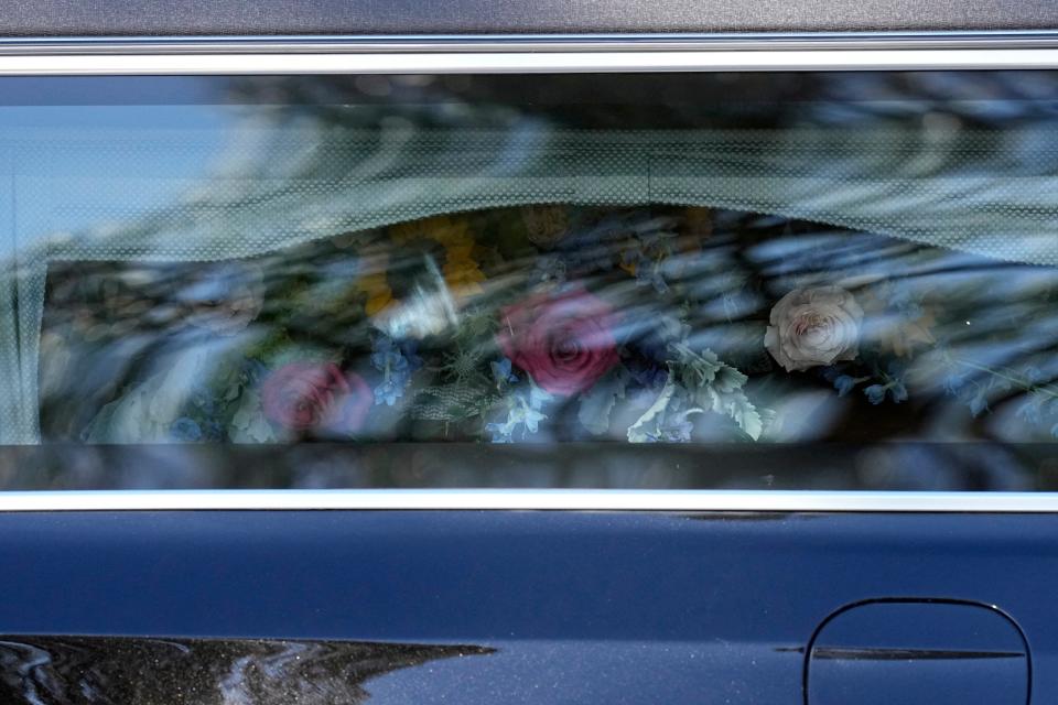 The casket of former US First Lady Rosalynn Carter is covered in flowers in the hearse (POOL/AFP via Getty Images)