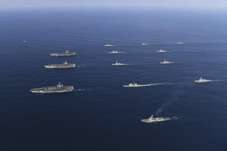 FILE - In this Nov. 12, 2017, file photo provided by South Korea Defense Ministry, three U.S. aircraft carriers USS Nimitz, left top, USS Ronald Reagan, left center, and USS Theodore Roosevelt, left bottom, participate with other U.S. and South Korean navy ships during the joint naval exercises between the United States and South Korea in waters off South Korea's eastern coast in South Korea. Ahead of the second summit between U.S. President Donald Trump and North Korean leader Kim Jong Un, some observers say there is an uncertainty over the future of the decades-long military alliance between Washington and Seoul. (South Korea Defense Ministry via AP, File)