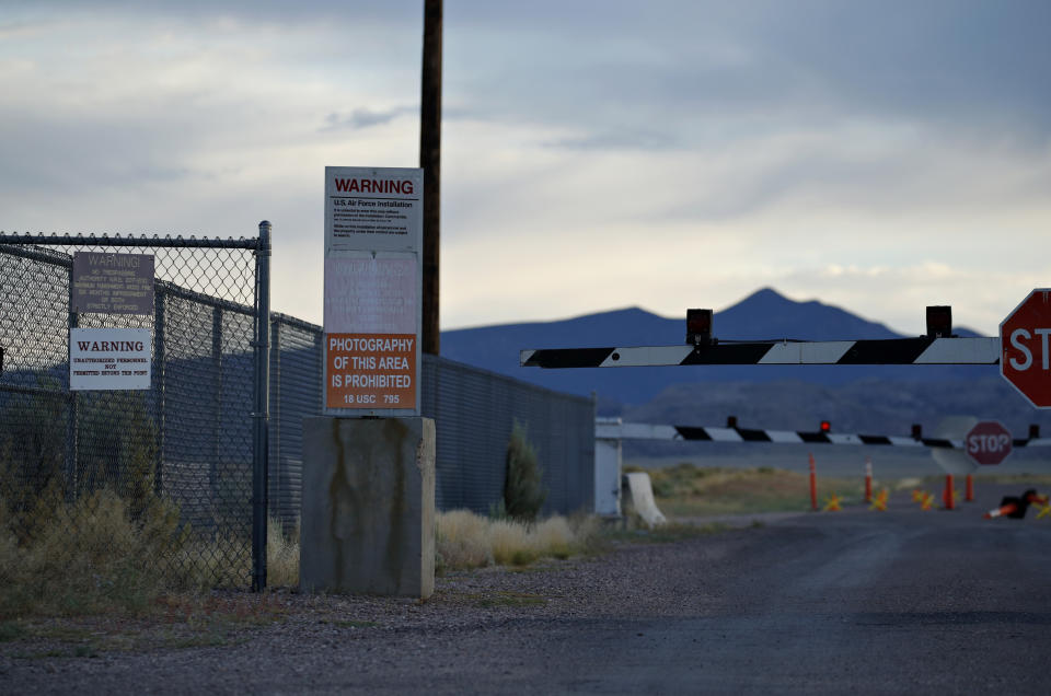 FILE - In this July 22, 2019 file photo, signs warn about trespassing at an entrance to the Nevada Test and Training Range near Area 51 outside of Rachel, Nev. A second rural Nevada county prepared Thursday for a "Storm Area 51" event that began as an internet joke but has drawn millions of social media fans. Organizers of the event hope people will gather and try to make their way into the once top-secret U.S. Air Force test area known in popular lore as a site for government studies of outer space aliens. An emergency declaration for Nye County took effect a day after county disaster preparation and sheriff officials told county lawmakers they're unsure how many — or where — people might show up for events Sept. 20-22. (AP Photo/John Locher)