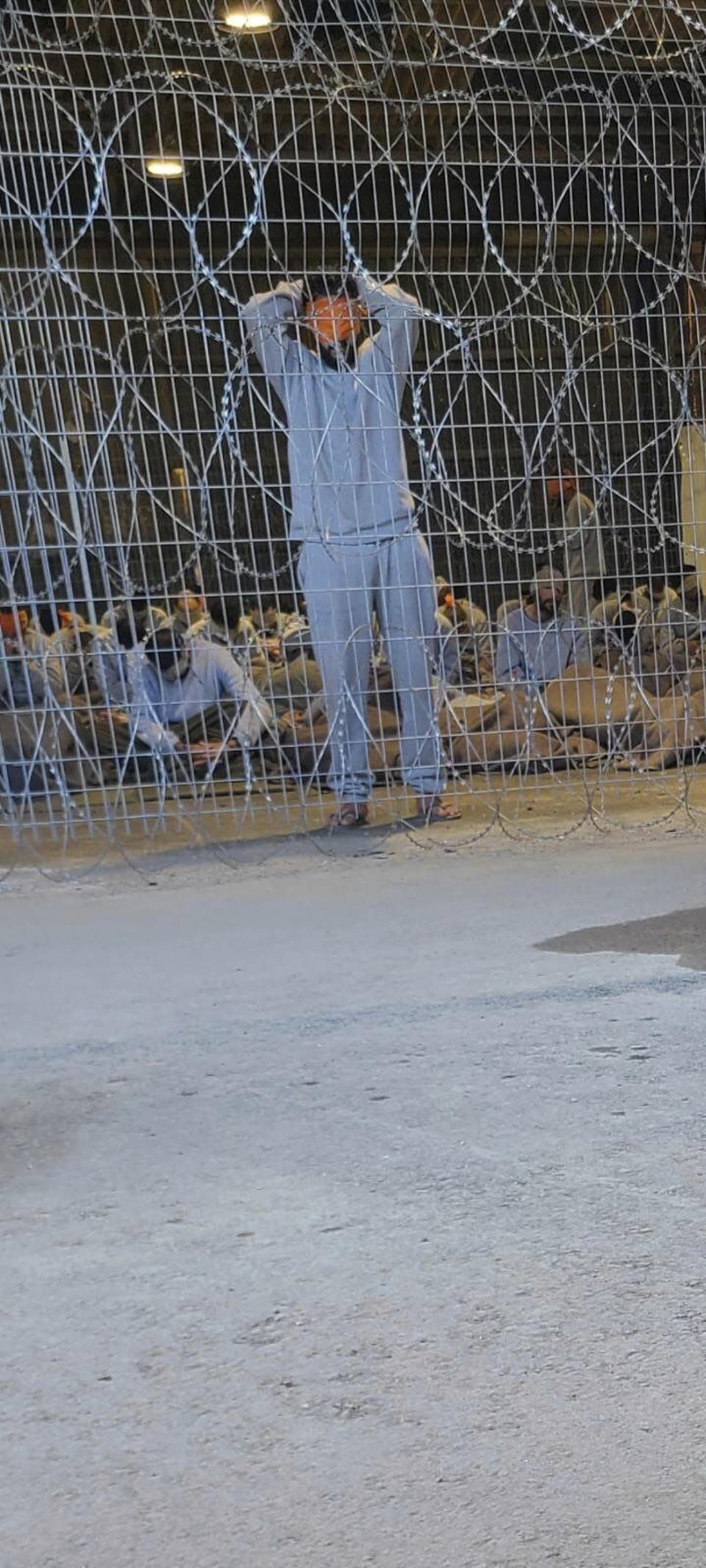 This undated photo taken in the winter 2023 and provided by Breaking the Silence, a whistleblower group of former Israeli soldiers, shows blindfolded Palestinians captured in the Gaza Strip in a detention facility on the Sde Teiman military base in southern Israel. (Breaking The Silence via AP)