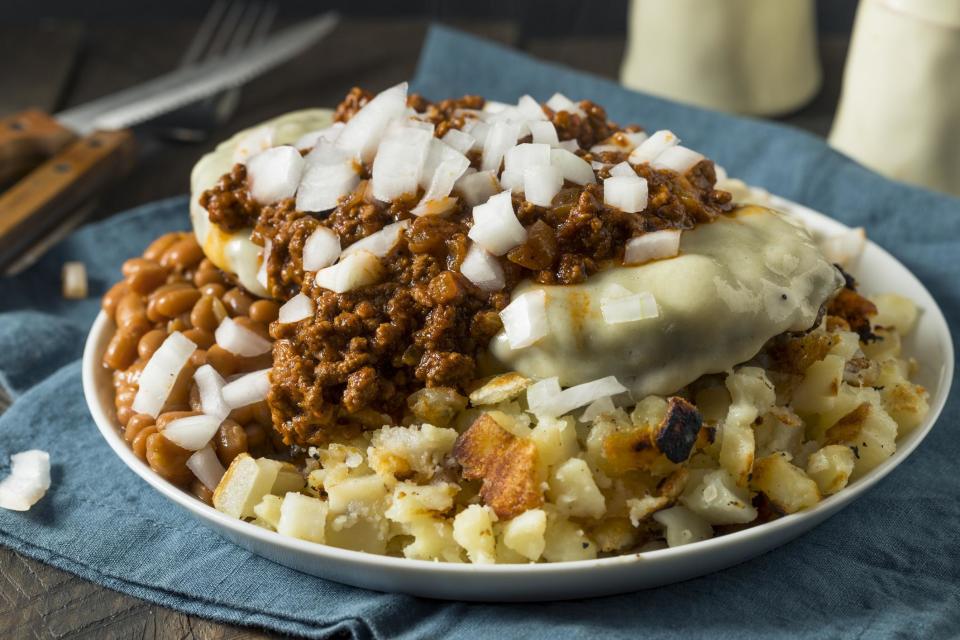 <p>Insanely popular in the Rochester, New York, area but little-known outside of it, the garbage plate gets its name because of the huge quantity and variety of food piled onto a plate. Widely credited with being created at a restaurant called Nick Tahou’s Hots, garbage plates start with either <a href="https://www.thedailymeal.com/cook/baked-beans-slow-cooker-barbecue?referrer=yahoo&category=beauty_food&include_utm=1&utm_medium=referral&utm_source=yahoo&utm_campaign=feed" rel="nofollow noopener" target="_blank" data-ylk="slk:baked beans;elm:context_link;itc:0;sec:content-canvas" class="link ">baked beans</a> or macaroni salad. Then, home fries or french fries are added and topped with your choice of hamburger, cheeseburger, Italian sausage, red or white hots, chicken or steak. But we're not done. It’s also topped with Rochester hot sauce, a spicy meat sauce, and you can also add onions and mustard. You can get this whole thing served with a side of buttered bread. Hangovers be damned.</p>