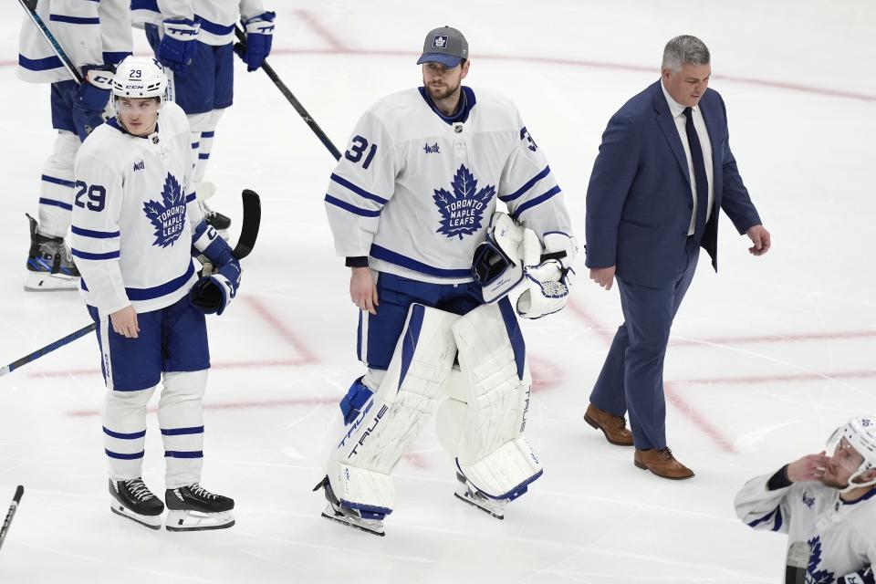 Toronto Maple Leafs head coach Sheldon Keefe, top right, Martin Jones (31) and Pontus Holmberg (29) prepare to shake hands with the Boston Bruins after losing in overtime during Game 7 of an NHL hockey Stanley Cup first-round playoff series, Saturday, May 4, 2024, in Boston. (AP Photo/Michael Dwyer)