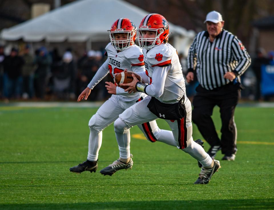 Byron quarterback Braden Smith runs around end during the Class 3A semifinal game against IC Catholic in Elmhurst on Saturday, Nov. 19, 2022.