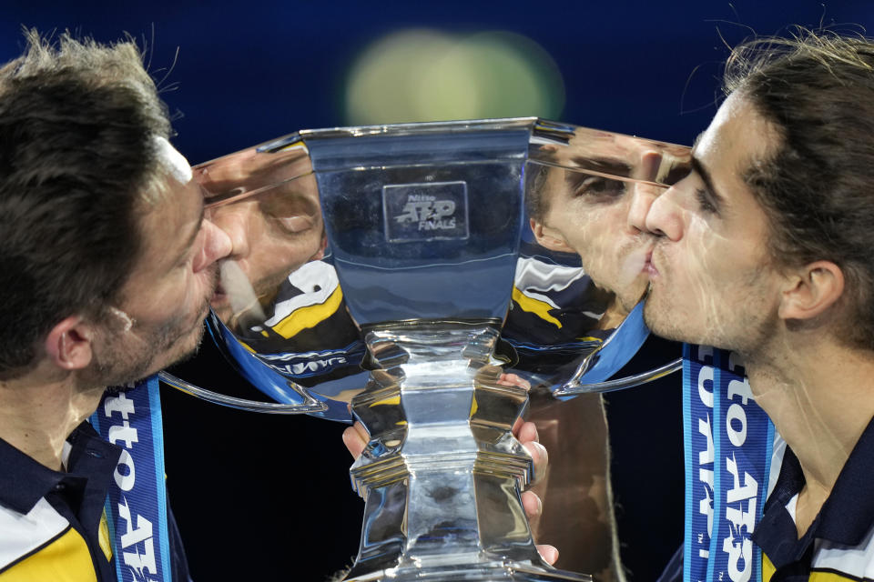 France's Pierre-Hugues Herbert and Nicolas Mahut, left, pose with their trophy after winning the doubles final tennis match of the ATP World Tour Finals, at the Pala Alpitour in Turin, Italy, Sunday, Nov. 21, 2021. Herbert and Mahut defeated Rajeev Ram of the United States and Britain's Joe Salisbury 6-4/7-6. (AP Photo/Luca Bruno)