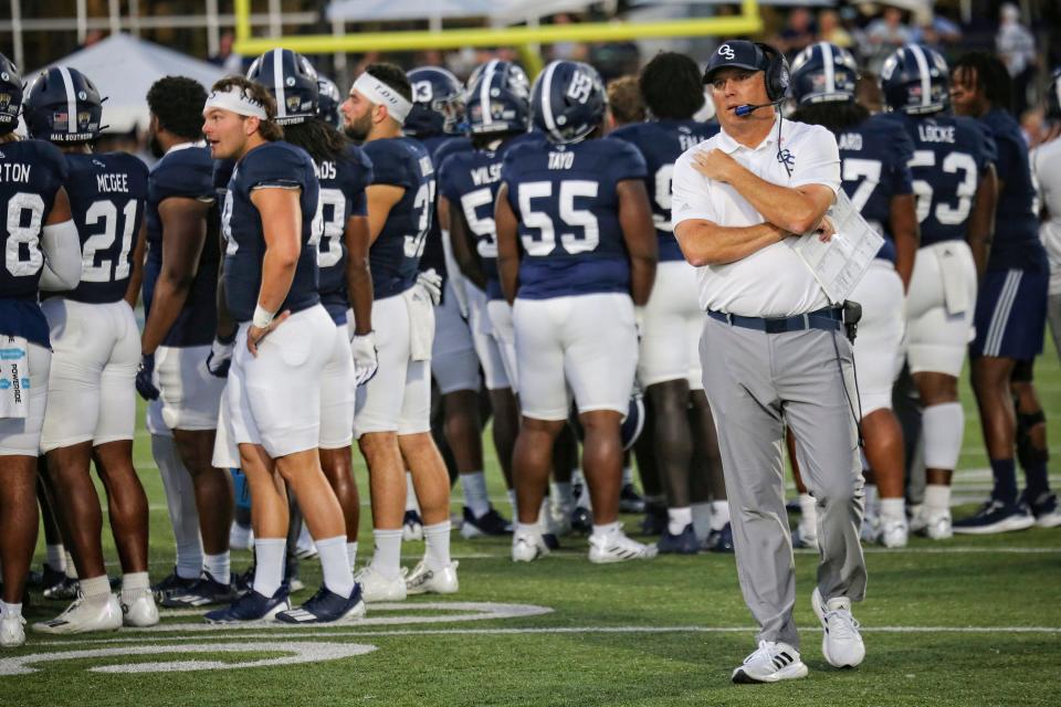 Georgia Southern coach Clay Helton talks strategy with the booth during a play review on Oct. 15 at Paulson Stadium in Stateboro, where the Eagle defeated then-No. 25 James Madison 45-38.