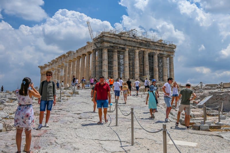 Tourists stand near the Parthenon at the Acropolis in Athens. On Monday, Greece began limiting visitors to the historical landmark to tackle overcrowding and prevent damage to the ruins. File photo by Thomas Maresca/UPI