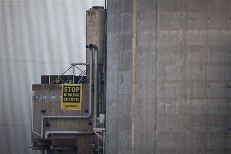 Greenpeace activists display an anti-nuclear banner after entering a nuclear power plant operated by EDF in Fessenheim, eastern France, March 18, 2014. REUTERS/Daniel Mueller/Greenpeace/Handout via Reuters