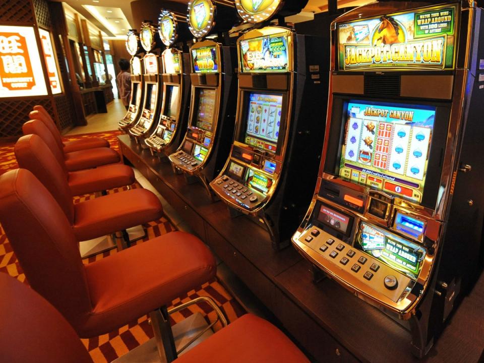 File: A row of slot machines await gamblers at the opening of Singapore's first casino, the Resorts World Sentosa complex, in Singapore (ROSLAN RAHMAN/AFP/Getty Images)