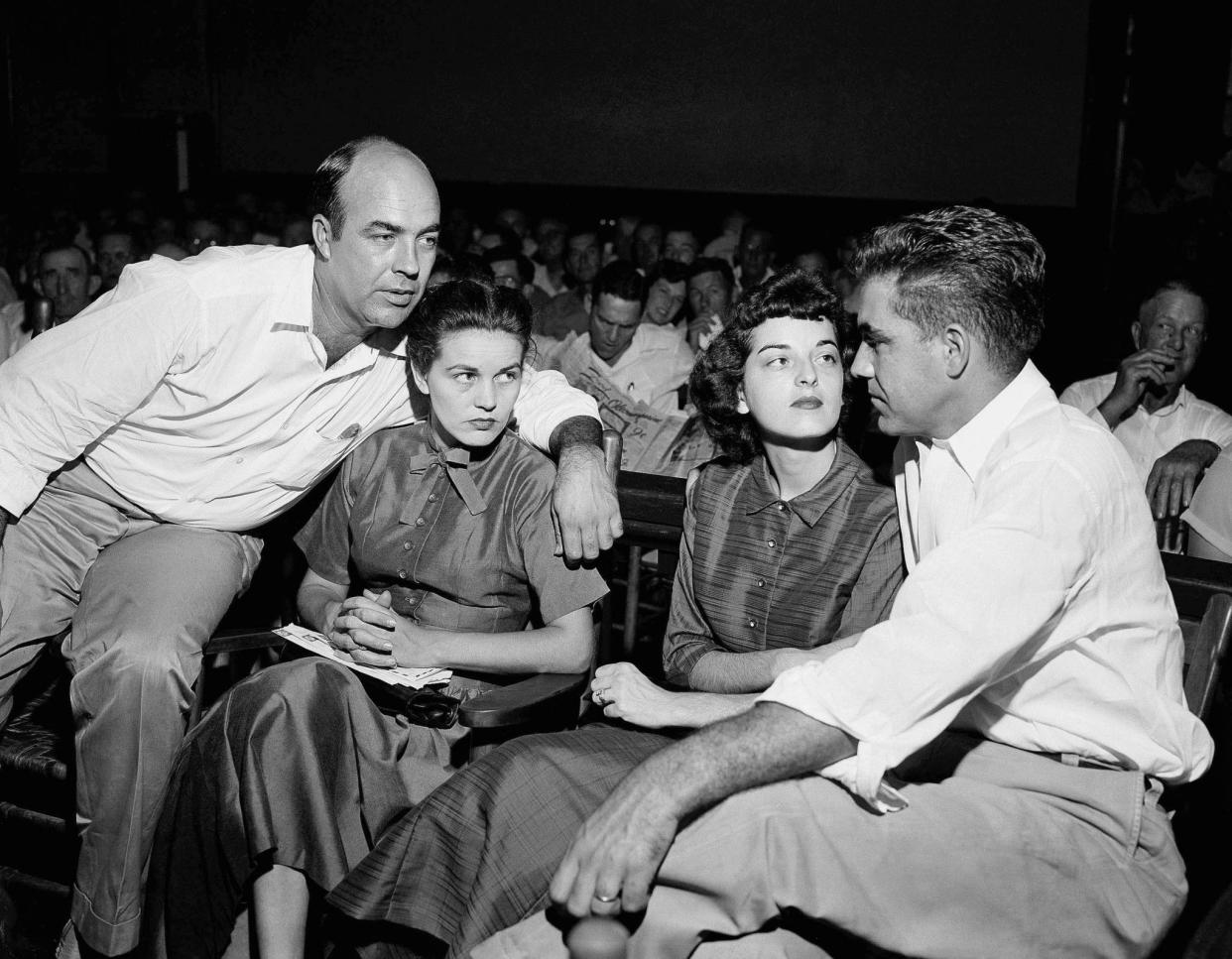 J.W. Milam, far left, and Roy Bryant, far right, sit with their wives in a Mississippi courtroom in 1955.