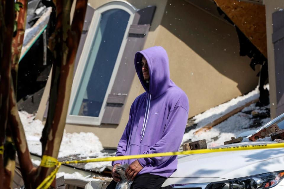 Tennessee Titans cornerback Caleb Farley sits outside of the rubble of his home after an explosion in Mooresville, N.C., Tuesday, Aug. 22, 2023. (@TheCharlotteObserver)