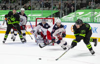 Dallas Stars left wing Roope Hintz (24) skates for the puck as Columbus Blue Jackets defenseman Andrew Peeke (2) pursues during the second period of an NHL hockey game Saturday, April 17, 2021, in Dallas. (AP Photo/Sam Hodde)